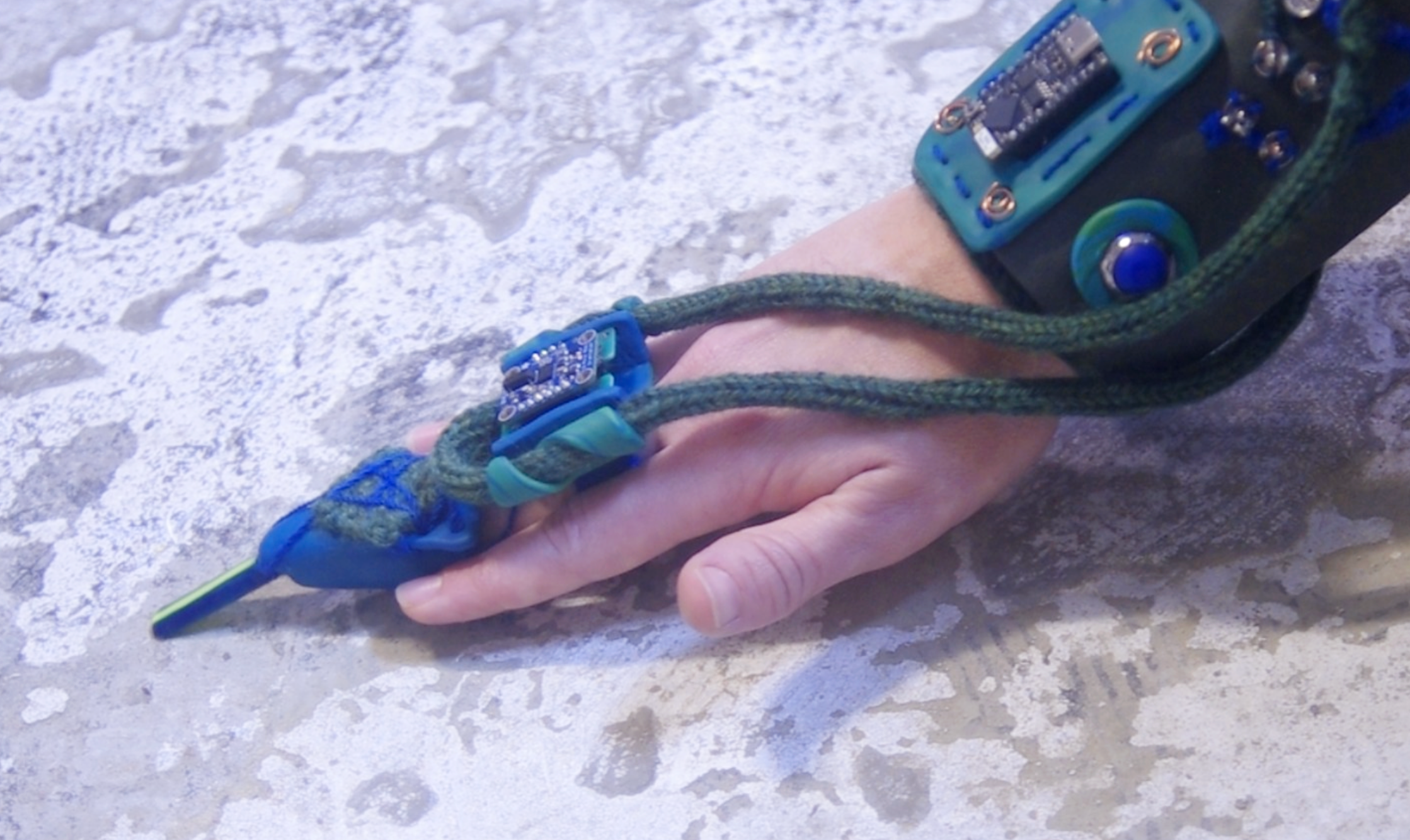 Image of a knitted wearable computing device on a hand.